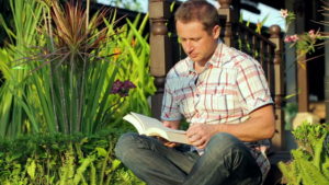 Man reading in the garden.